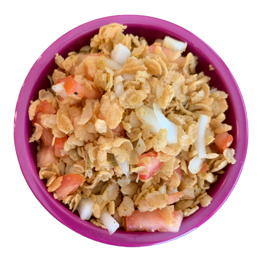 Jazzed Puffed Rice Salad with Super Mirchi Hot Sauce, Tangy Mirchi, fresh tomatoes and onion in a bowl