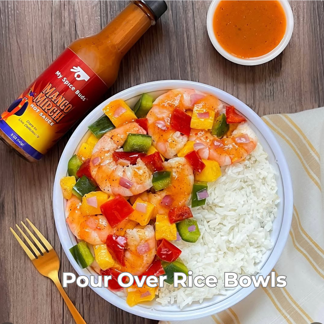 Shrimp and vegetable bowl with a bottle of 'My Spice Buds Mango Mirchi' hot sauce on a wooden table.