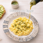 Scrambled eggs on a decorative plate with a drizzle of green super mirchi sauce, accompanied by toast with avocado. 8
