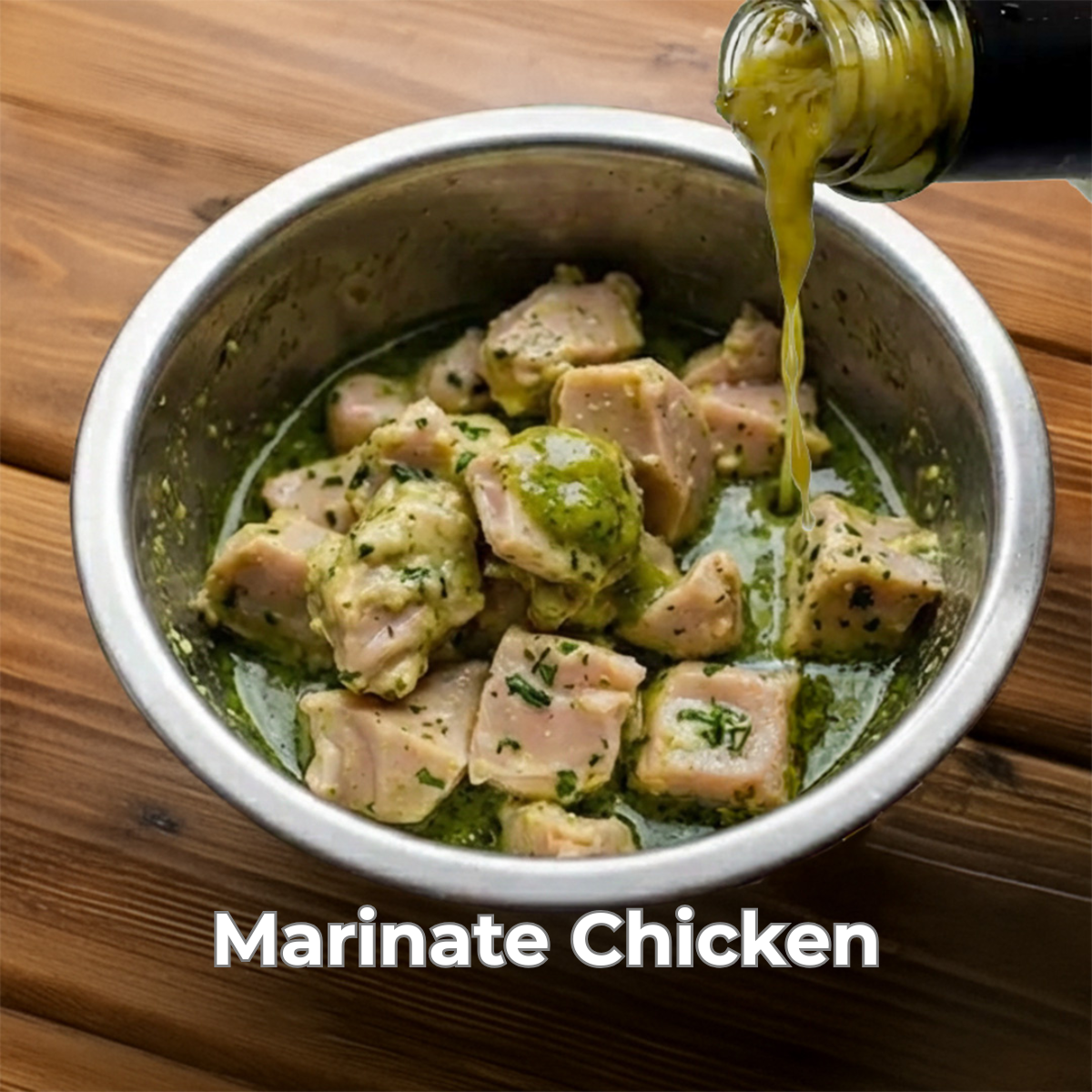 Marinating chicken in a bowl with super mirchi being poured over it on a wooden surface.